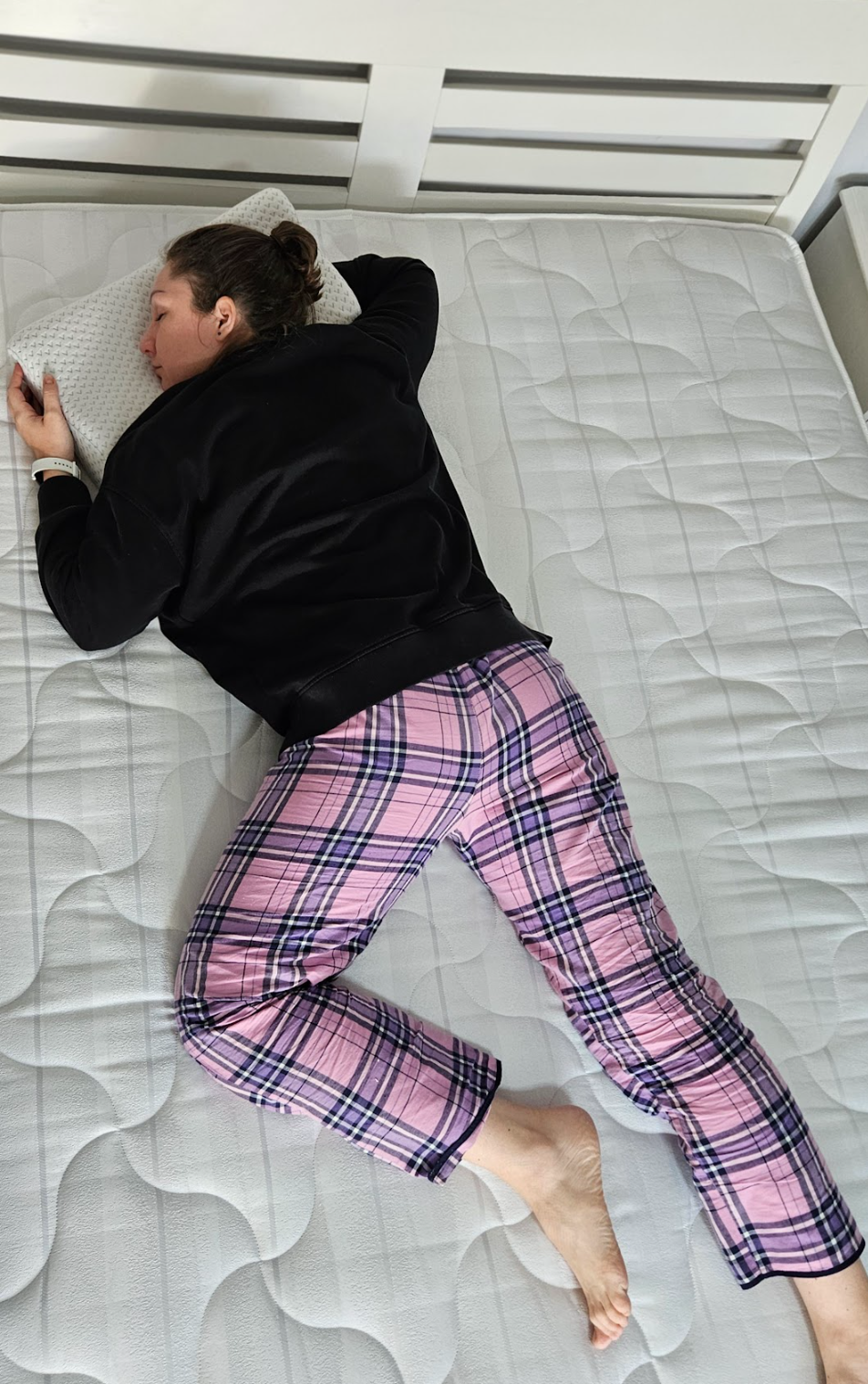 Person lying on new mattress showing improved support